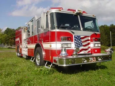 Front-right exterior view showing cab, bumper, and side body