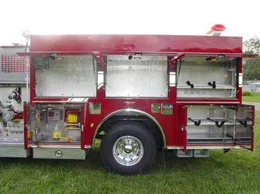 Open driver-side compartments showing tools, shelves, and equipment trays