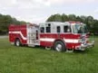 Pumper front-left exterior view showing enclosed cab and side compartments