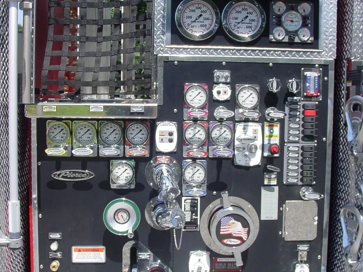 Pump panel close-up showing gauges, intake and discharge controls, and pressure dials.