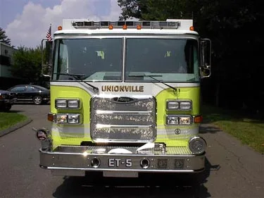 Front exterior view showing grille, bumper, and warning lights