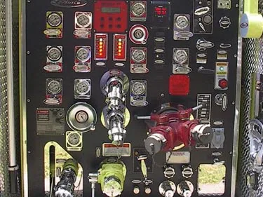Pump panel close-up showing gauges, valves, and intake fittings