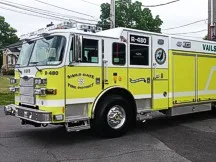 Wide front-left thumbnail view of the rescue pumper parked by the station.