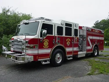 Front-left exterior view showing bumper, cab, and side body