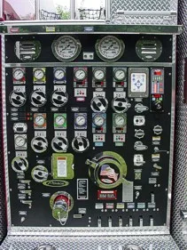 Pump panel close-up showing gauges, valves, and control levers