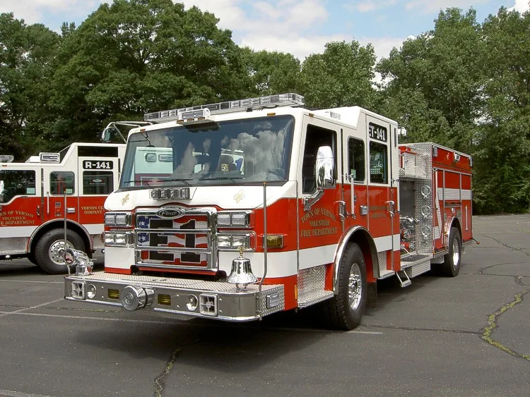 Front-left exterior view showing cab, bumper, and side body