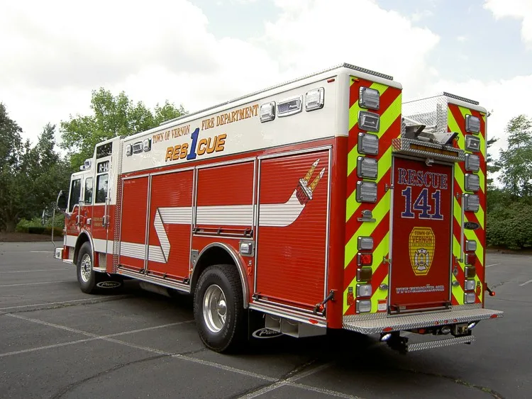 Rear-left exterior view showing side body and chevron-striped tail