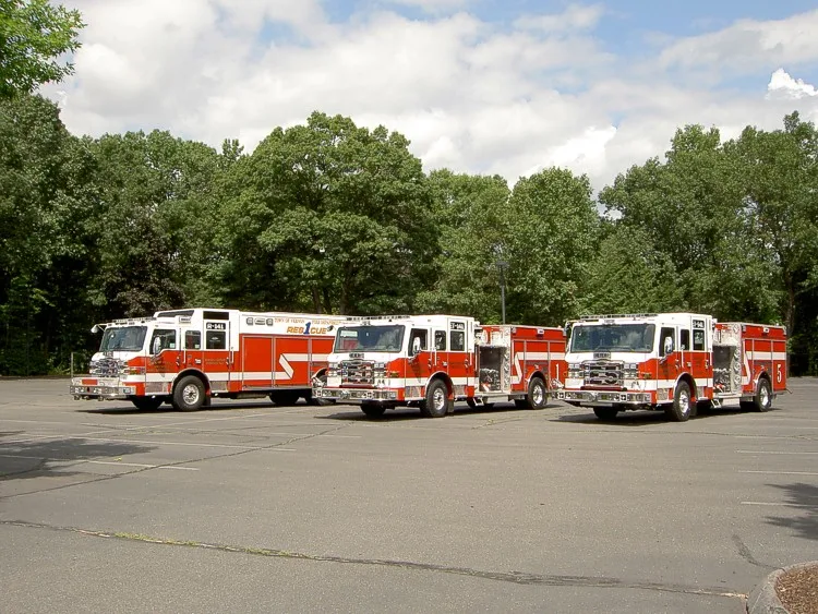 Wide side view showing multiple apparatus parked in formation