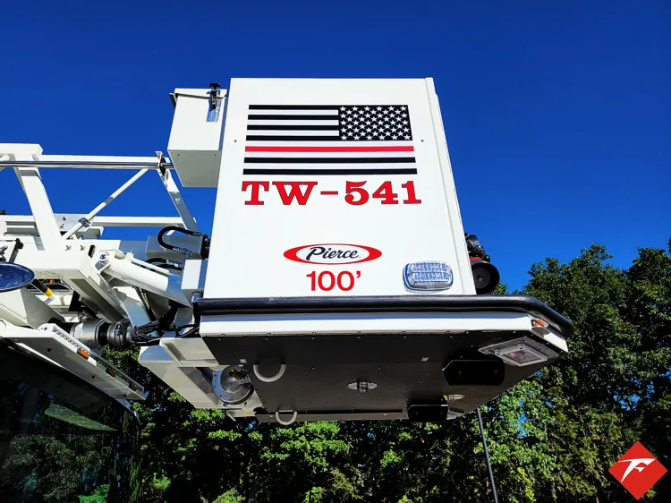 Aerial bucket and ladder tip close-up showing platform safety rails