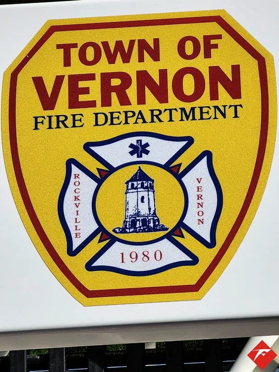 Cab door close-up showing shield-style fire department crest