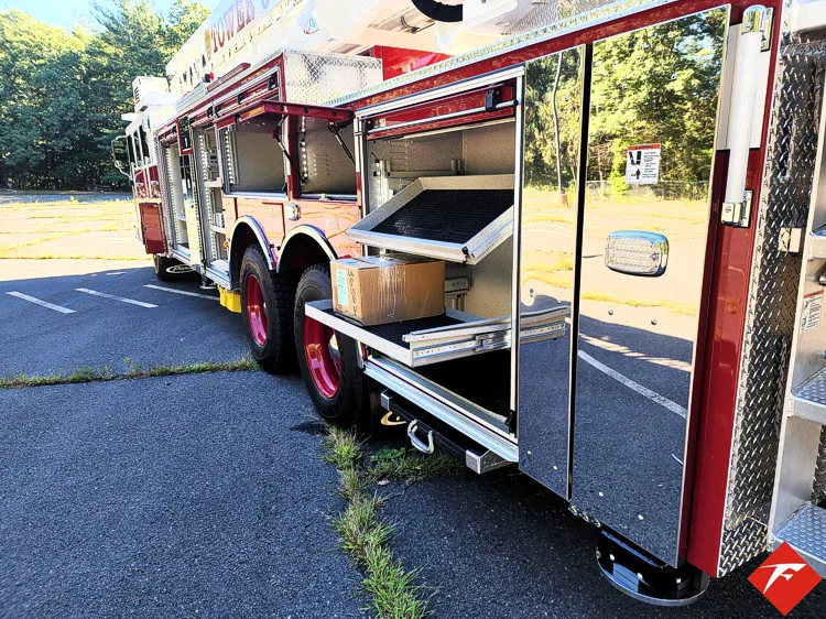 Open side compartment showing long storage bay and lower trays