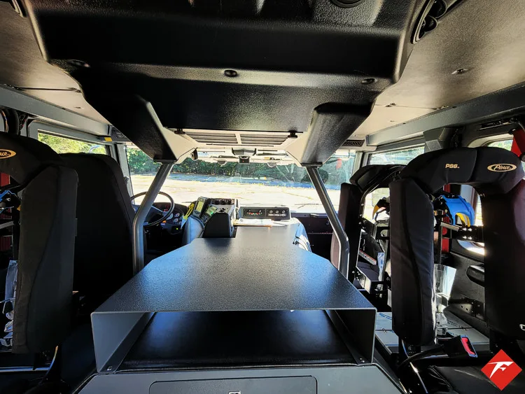 Cab interior wide view showing center aisle, seats, and storage cabinet