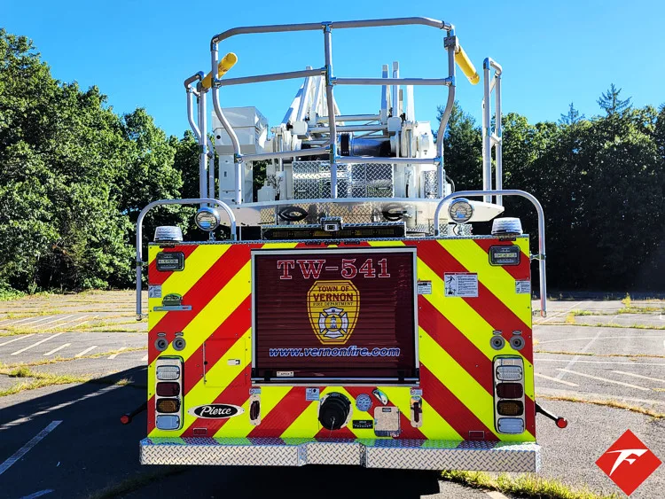 Rear view showing chevrons, rear warning lights, and bucket at ladder tip