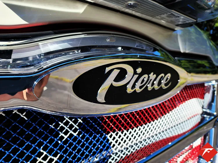 Front grille close-up showing Pierce badge on chrome mesh