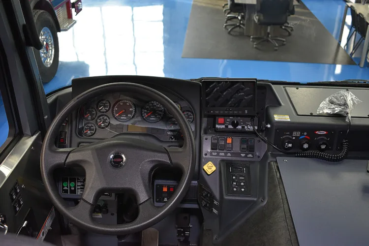 Driver cockpit view showing steering wheel, dashboard, and center console