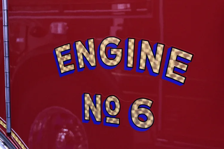 Body side lettering close-up showing unit designation on red paint