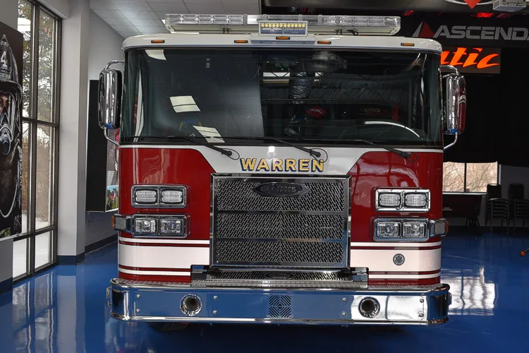 Head-on front view showing grille and cab inside apparatus bay
