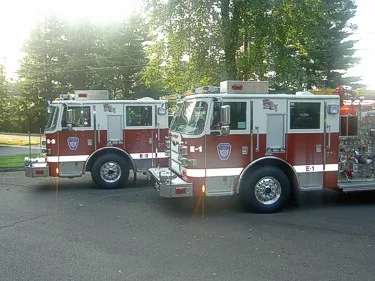 Two-apparatus side profile view showing pumper bodies and wheel areas