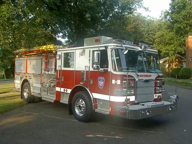 Pumper front-right exterior view showing bumper, cab, and side compartments