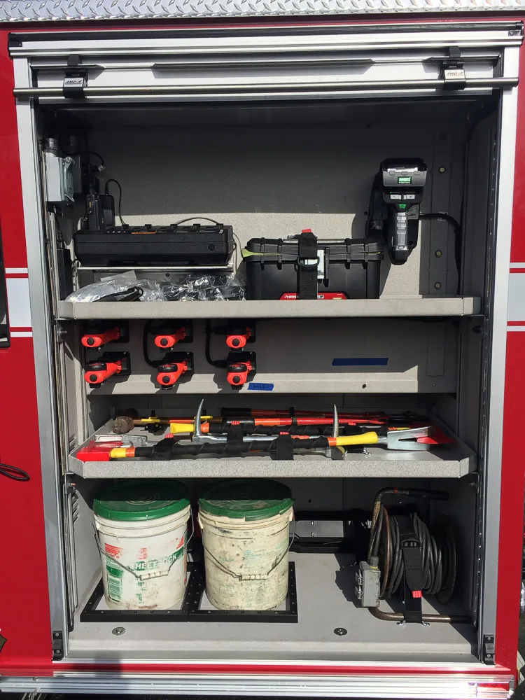 Driver-side profile indoors showing pump panel and side compartments