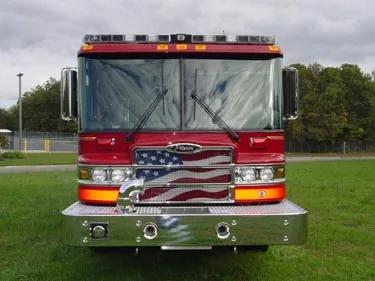 Head-on front view showing grille, bumper inlets, and warning light bar
