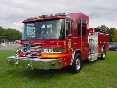 Front-left exterior profile showing cab, pump panel section, and side body
