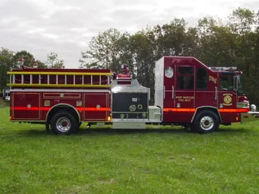 Passenger-side full profile showing side body, pump panel enclosure, and wheel layout