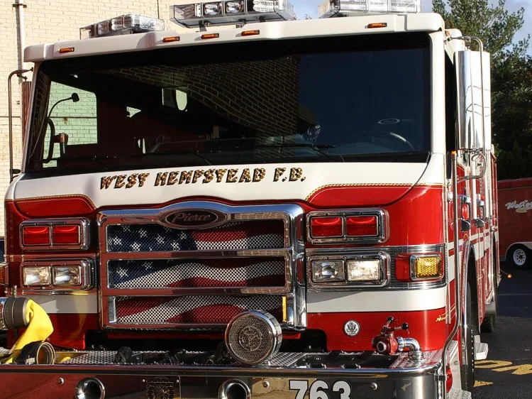 Head-on front view showing grille, bumper, and warning lights