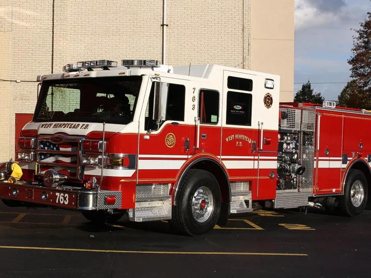 Front-left exterior profile showing pumper body and rear wheel area