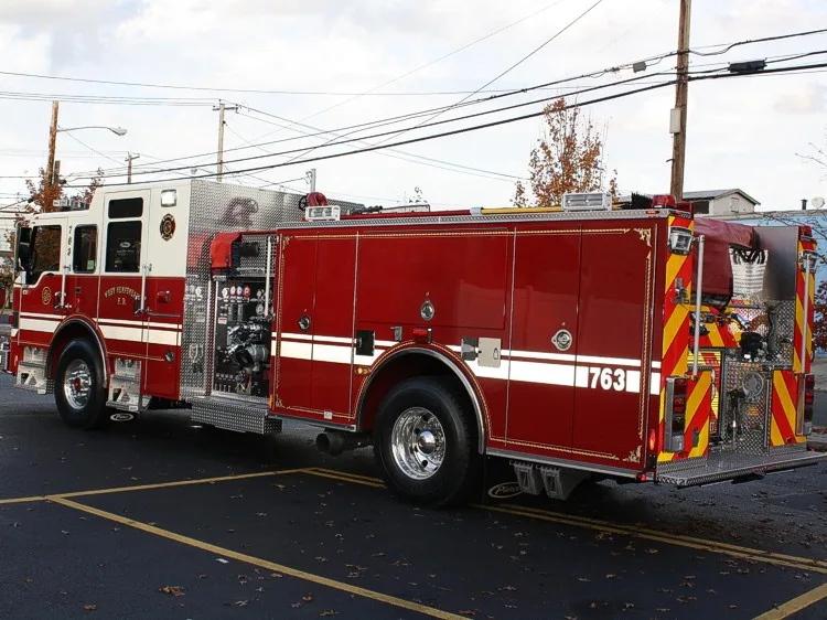 Rear-right exterior view showing side body and rear warning lights