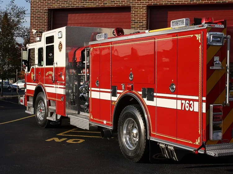 Rear-left exterior profile showing pumper body and side compartments