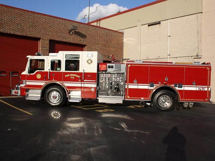 Driver-side profile view parked beside station building