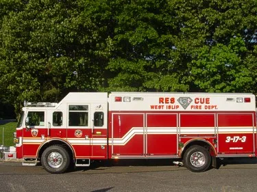 Driver-side full profile showing the rescue body compartments and cab doors.