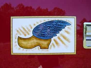 Side emblem close-up showing wing graphic on maroon panel