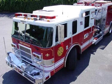 High front-left exterior view showing bumper, cab, and side compartments