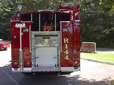 Rear view showing rear door panel, warning lights, and upper hosebed