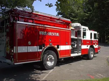 Rear-right exterior view showing side hosebed rails and rear wheel area