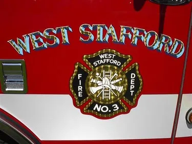 Shield logo close-up on side panel with department text