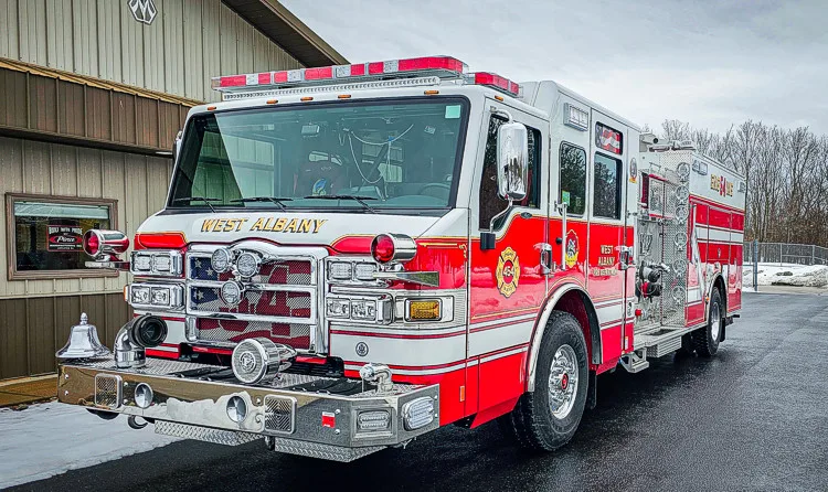 Front-left exterior profile showing pumper parked near building