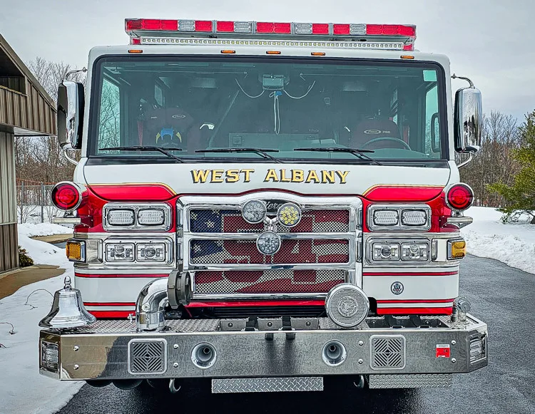 Head-on front view showing grille, bumper, and warning lights
