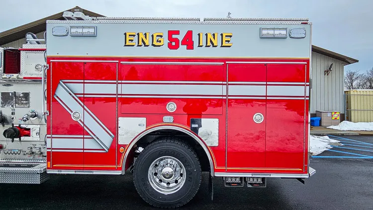 Driver-side profile view showing side body and rear wheel section