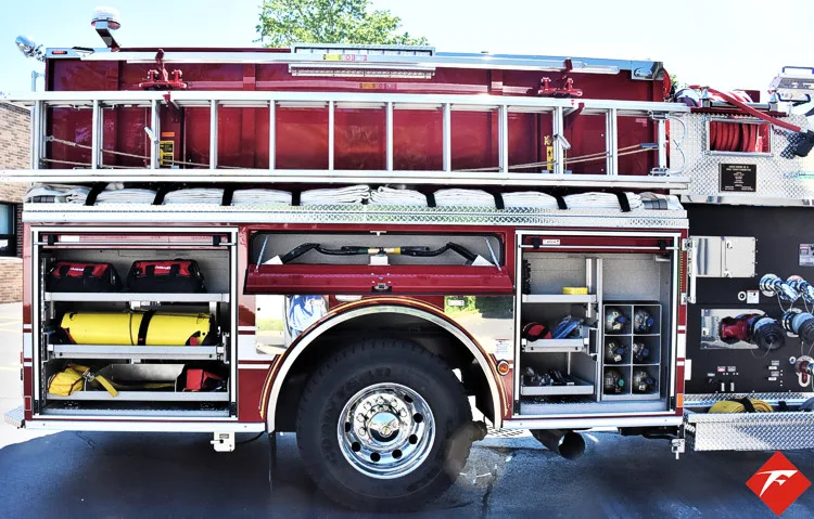 Driver-side mid-body view with open compartments showing hose and tools