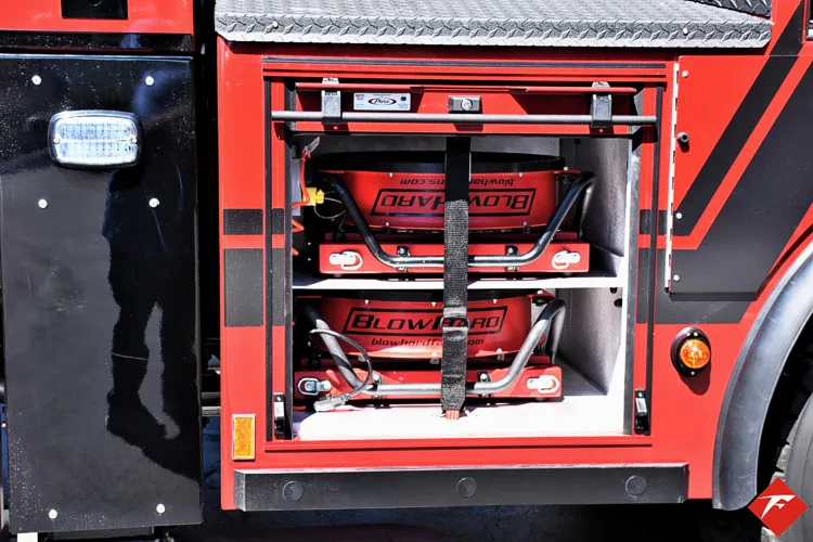 Open compartment close-up showing rescue saws and strapped equipment