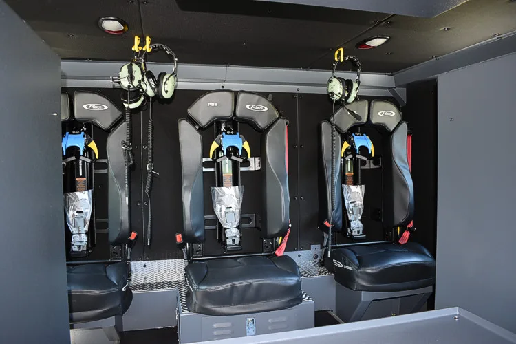 Open compartment showing mounted SCBA packs and seatback brackets