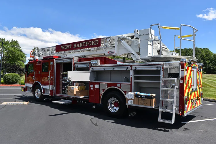 Driver-side profile view showing tower ladder body and rear wheel area