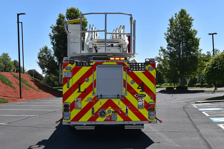 Rear view showing red-and-yellow chevrons and bucket platform rails