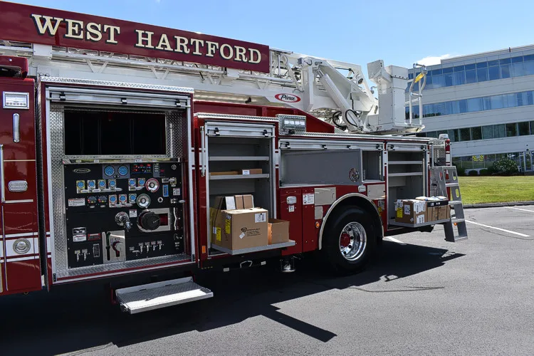 Driver-side profile with open compartment showing pump controls and side storage