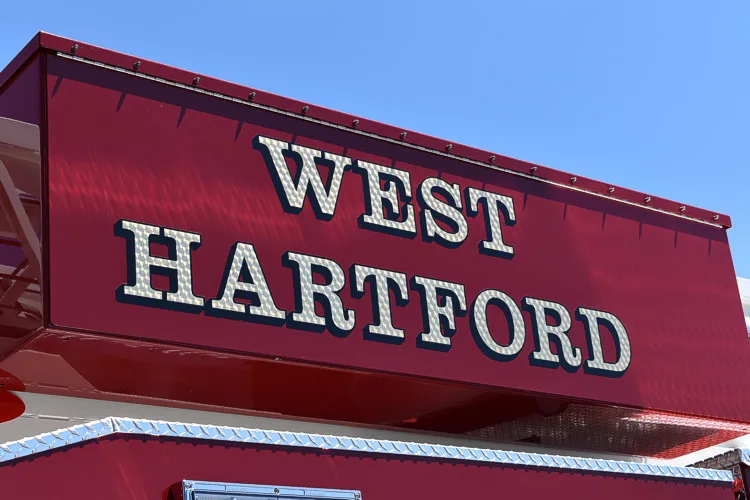 Body side lettering close-up in white text on red panel