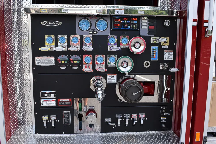 Pump panel close-up showing gauges, valves, and intake controls