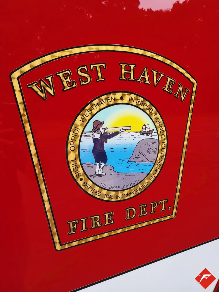 Cab door close-up showing circular city fire crest on red panel